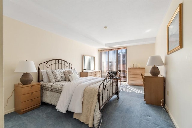 bedroom with baseboards and dark carpet