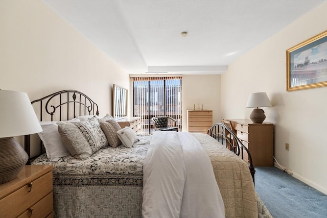 bedroom featuring carpet and baseboards