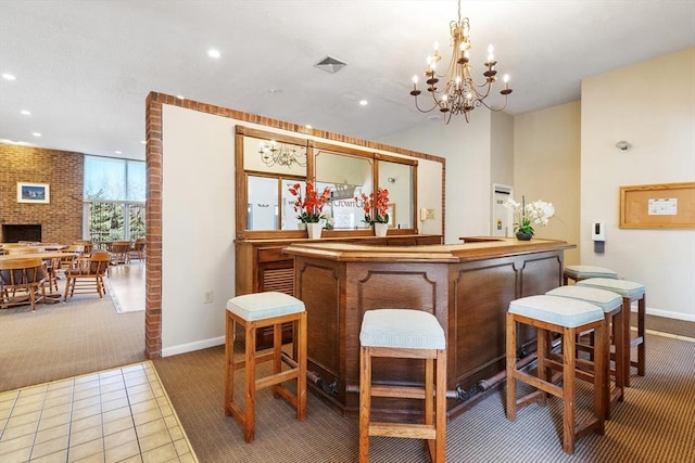 bar with visible vents, recessed lighting, brick wall, carpet flooring, and a brick fireplace