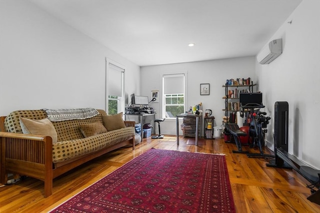 166 Littleton Unit 3, Harvard, MA 01451 - living room featuring an AC wall unit, wood finished floors, and recessed lighting