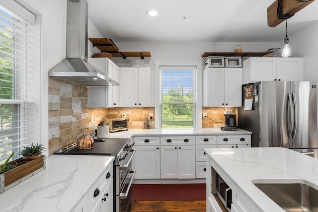 166 Littleton Unit 3, Harvard, MA 01451 - kitchen with appliances with stainless steel finishes, wall chimney exhaust hood, recessed lighting, white cabinets, and pendant lighting