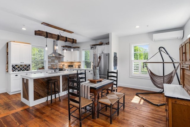 166 Littleton Unit 3, Harvard, MA 01451 - dining space with a wall mounted AC, healthy amount of natural light, dark wood-style floors, and recessed lighting