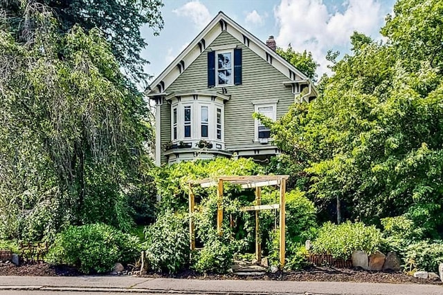 239 Arlington St, Acton, MA 01720 - rear view of house with a chimney
