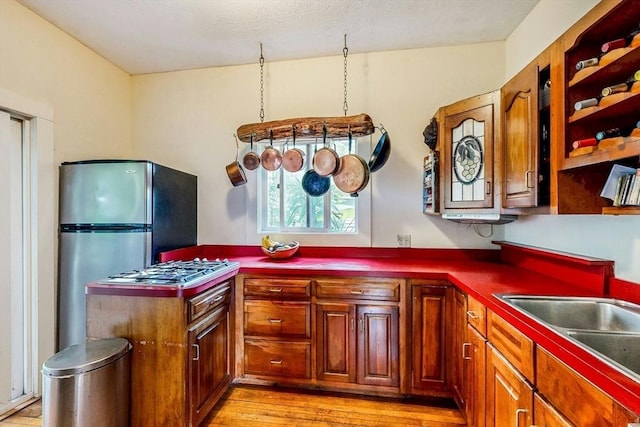 239 Arlington St, Acton, MA 01720 - kitchen featuring light wood finished floors, freestanding refrigerator, and brown cabinets