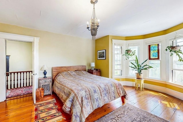 239 Arlington St, Acton, MA 01720 - bedroom with hardwood / wood-style flooring and a chandelier