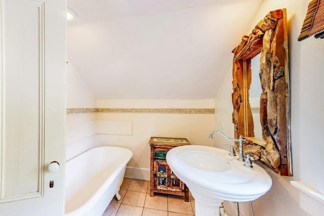 239 Arlington St, Acton, MA 01720 - bathroom with a soaking tub, lofted ceiling, and tile patterned floors