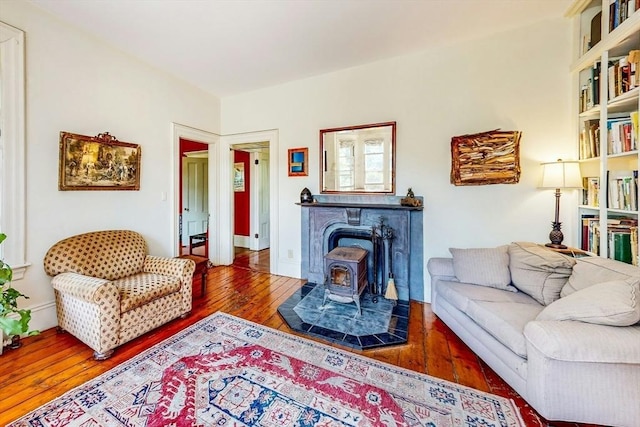 239 Arlington St, Acton, MA 01720 - living area featuring hardwood / wood-style flooring and a wood stove