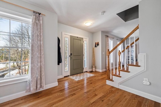 foyer entrance featuring wood-type flooring and a wealth of natural light