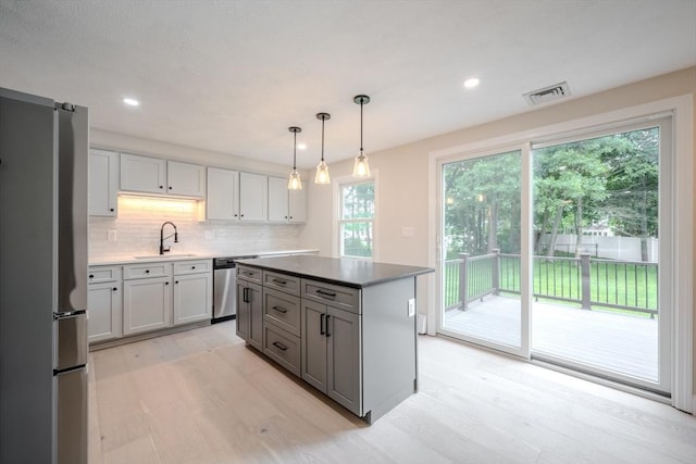 5 Betsy Ln Unit 5, Chelmsford, MA 01824 - kitchen featuring appliances with stainless steel finishes, light wood-type flooring, backsplash, recessed lighting, and a center island