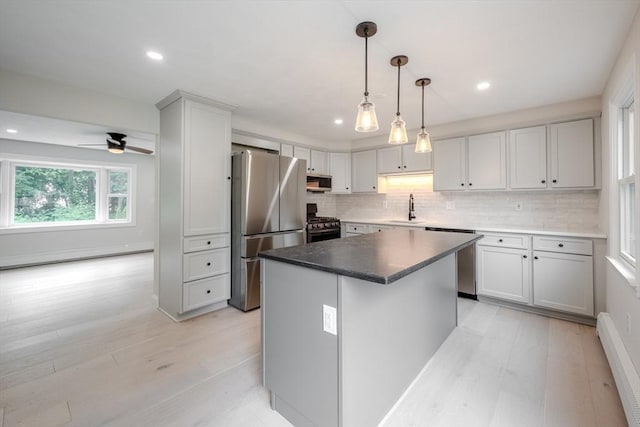 5 Betsy Ln Unit 5, Chelmsford, MA 01824 - kitchen featuring stainless steel appliances, a baseboard radiator, light wood finished floors, recessed lighting, and decorative backsplash
