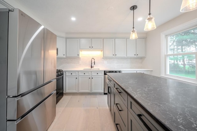 5 Betsy Ln Unit 5, Chelmsford, MA 01824 - kitchen featuring appliances with stainless steel finishes, light wood-style flooring, recessed lighting, decorative backsplash, and dark stone countertops