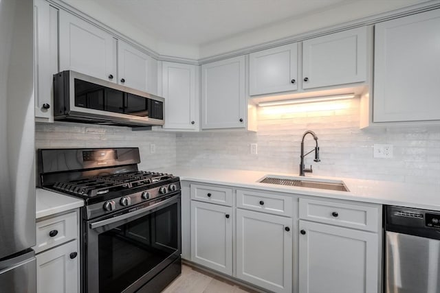 5 Betsy Ln Unit 5, Chelmsford, MA 01824 - kitchen with stainless steel appliances, light countertops, backsplash, and white cabinetry
