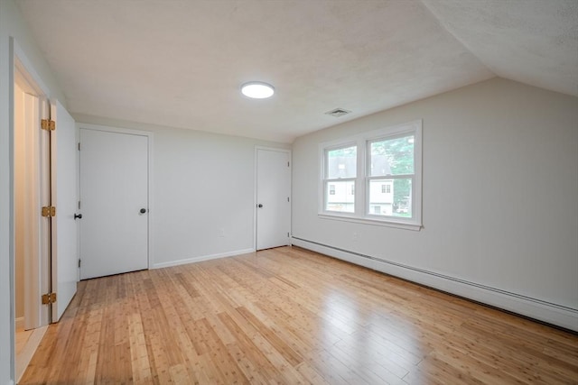 5 Betsy Ln Unit 5, Chelmsford, MA 01824 - unfurnished bedroom with a baseboard heating unit, light wood-style flooring, and lofted ceiling
