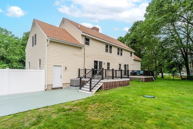 5 Betsy Ln Unit 5, Chelmsford, MA 01824 - back of property with a deck, a patio area, a chimney, and roof with shingles