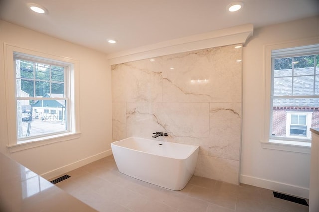 182 Merrimac St Unit 1, Newburyport, MA 01950 - full bathroom featuring healthy amount of natural light, a soaking tub, recessed lighting, and tile patterned floors