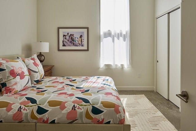 bedroom featuring baseboards and a closet