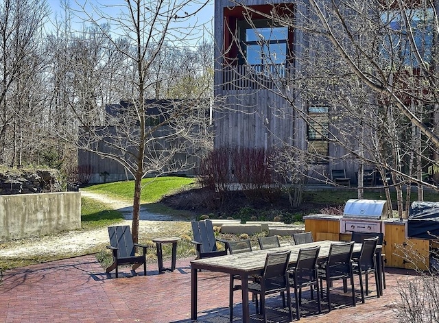view of patio with outdoor dining area and a grill