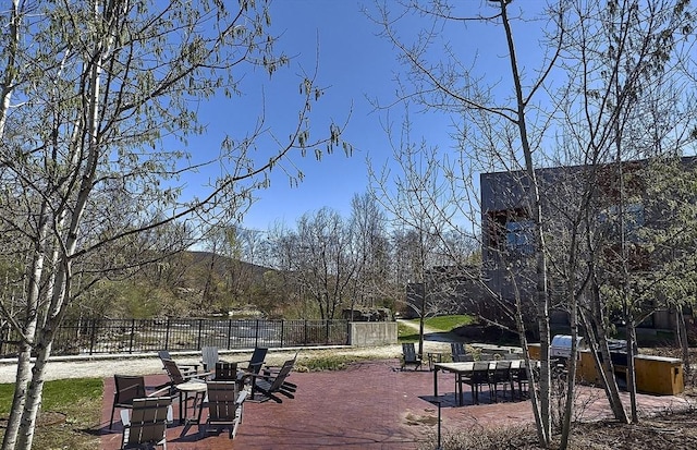 view of community featuring a patio and fence
