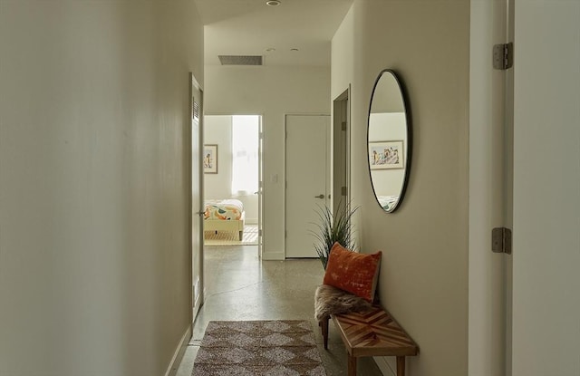 corridor with baseboards and visible vents