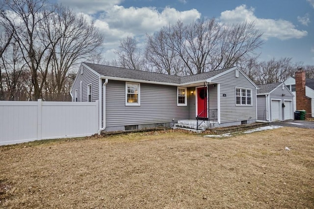 view of front of property featuring a front yard, a garage, and an outdoor structure