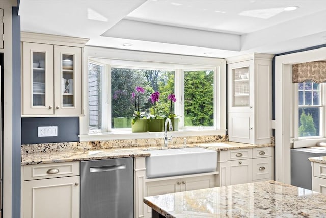148 Pond St, Cohasset, MA 02025 - kitchen featuring stainless steel dishwasher, a sink, glass insert cabinets, white cabinets, and light stone countertops