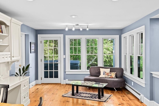 148 Pond St, Cohasset, MA 02025 - sitting room featuring baseboard heating, plenty of natural light, light wood finished floors, and baseboards