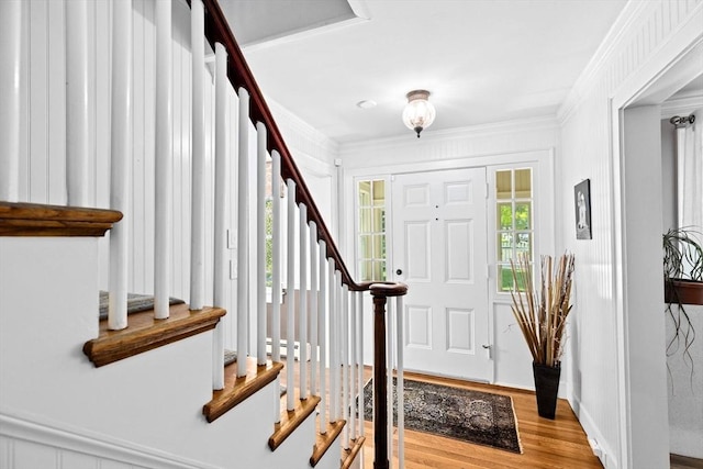 148 Pond St, Cohasset, MA 02025 - entryway with plenty of natural light, wood finished floors, stairs, crown molding, and a baseboard heating unit