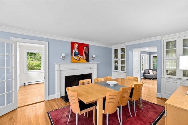 148 Pond St, Cohasset, MA 02025 - dining space featuring a brick fireplace, light wood finished floors, ornamental molding, and a baseboard radiator
