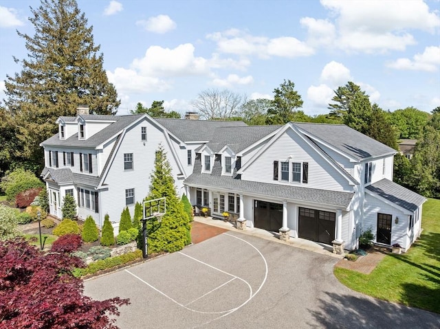 148 Pond St, Cohasset, MA 02025 - view of front of house with a chimney, asphalt driveway, a garage, and a shingled roof