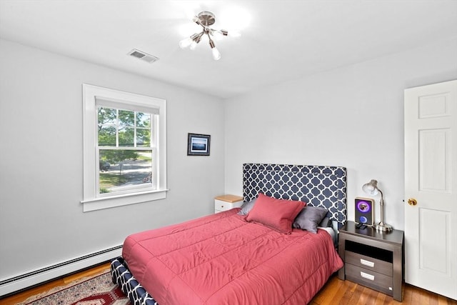 148 Pond St, Cohasset, MA 02025 - bedroom with a baseboard heating unit and wood finished floors