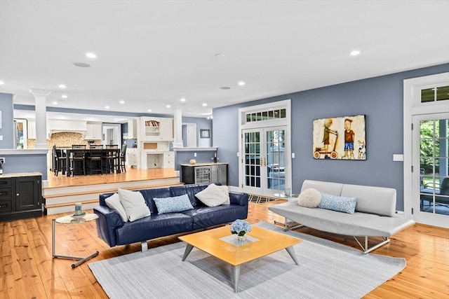 148 Pond St, Cohasset, MA 02025 - living area featuring ornate columns, light wood finished floors, recessed lighting, and bar area