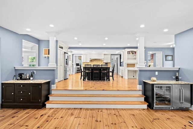 148 Pond St, Cohasset, MA 02025 - dining space with decorative columns, wine cooler, bar area, and recessed lighting