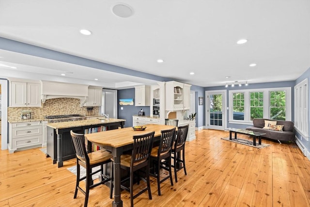 148 Pond St, Cohasset, MA 02025 - dining space with light wood-style flooring, recessed lighting, and baseboards