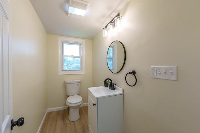 76 Wolcott Ave, West Springfield, MA 01089 - bathroom featuring wood finished floors, vanity, toilet, and baseboards