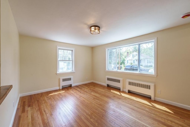76 Wolcott Ave, West Springfield, MA 01089 - unfurnished room with radiator heating unit, wood finished floors, and baseboards