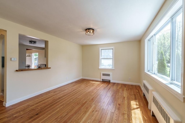 76 Wolcott Ave, West Springfield, MA 01089 - unfurnished room with radiator heating unit, light wood finished floors, and healthy amount of natural light