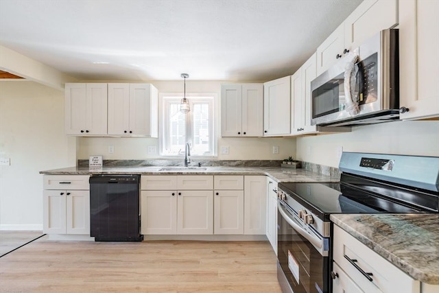 76 Wolcott Ave, West Springfield, MA 01089 - kitchen with appliances with stainless steel finishes, a sink, light wood-style flooring, and white cabinets