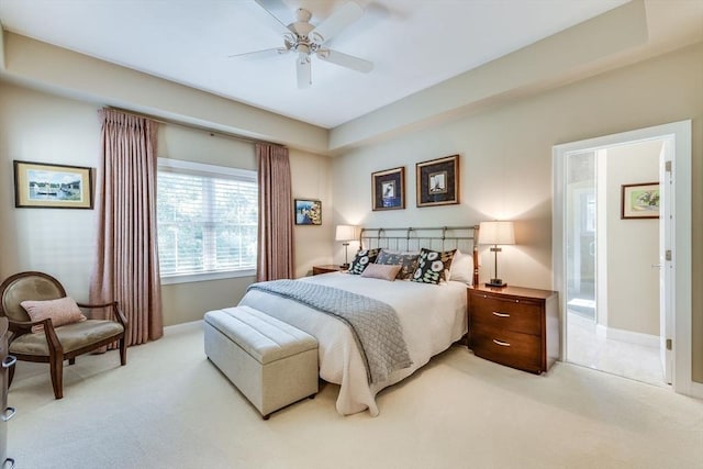 bedroom with light colored carpet, baseboards, and ceiling fan