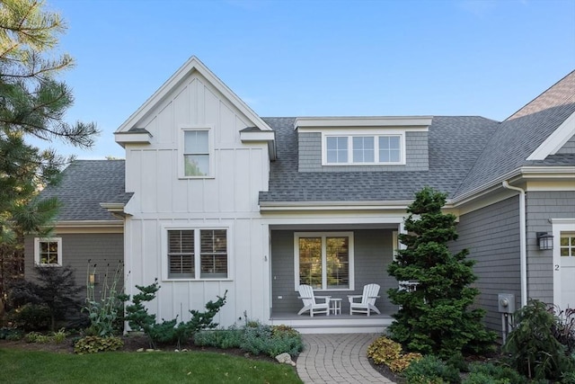 view of front facade featuring a porch, board and batten siding, and a shingled roof