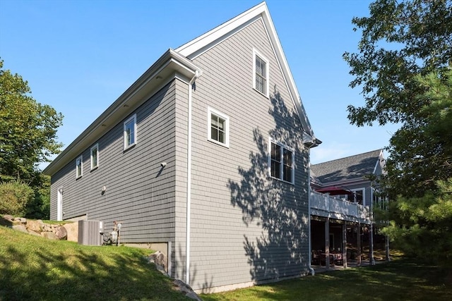 view of property exterior featuring a lawn and a deck