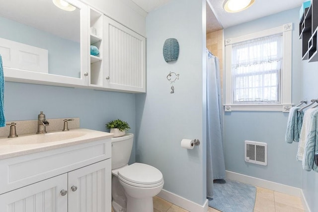 bathroom featuring a shower with shower curtain, toilet, vanity, tile patterned flooring, and baseboards