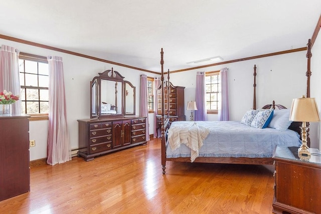 bedroom featuring light wood-style floors, multiple windows, and ornamental molding