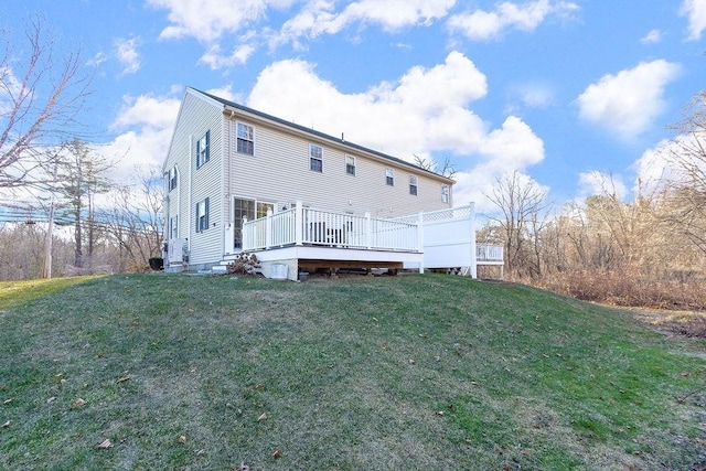 rear view of house with a yard and a deck