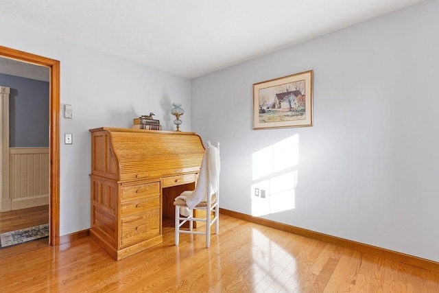 home office with baseboards and light wood finished floors