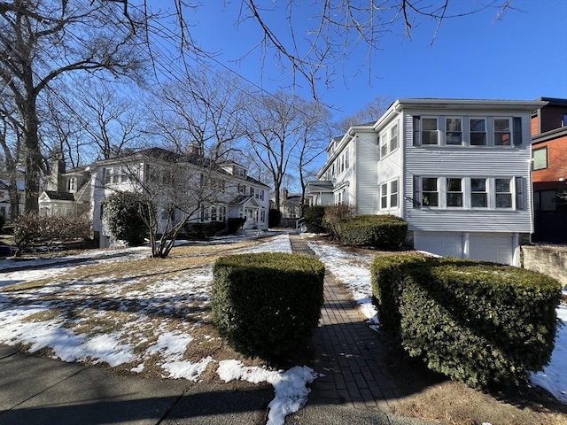 view of snow covered exterior with a garage