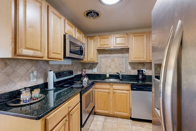 95 Maple St Unit 21, Malden, MA 02148 - kitchen with a sink, decorative backsplash, light tile patterned floors, light brown cabinets, and appliances with stainless steel finishes