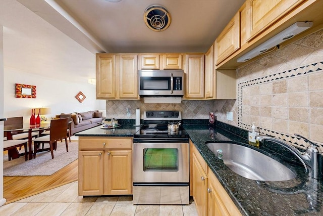 95 Maple St Unit 21, Malden, MA 02148 - kitchen featuring light tile patterned floors, stainless steel appliances, decorative backsplash, and a sink