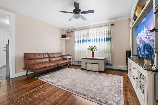 living room featuring dark wood-type flooring and ceiling fan