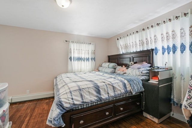 bedroom featuring baseboard heating and dark hardwood / wood-style flooring