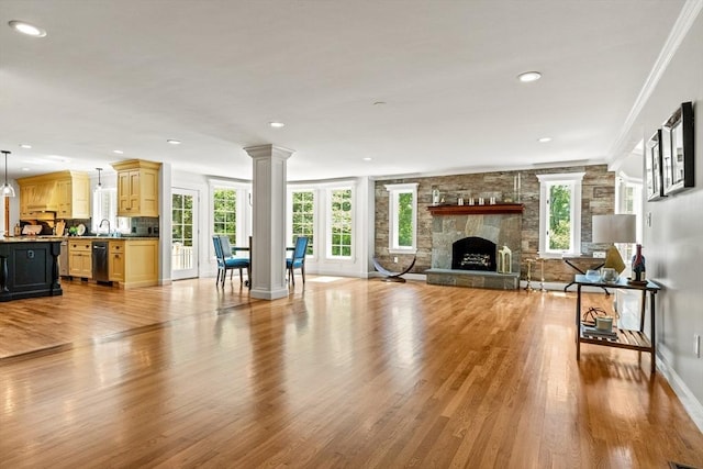 11 Ashford Ln, Andover, MA 01810 - living area with light wood finished floors, a fireplace, recessed lighting, decorative columns, and crown molding